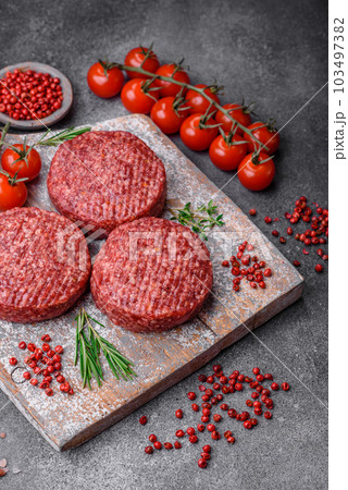 Fresh raw ground beef burger patty with salt and spices Fresh raw ground beef burger patty with salt and spices 103497382