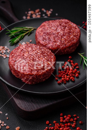 Fresh raw ground beef burger patty with salt and spices Fresh raw ground beef burger patty with salt and spices 103497399