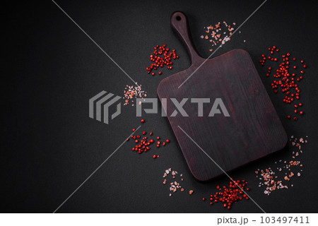 Empty wooden cutting board with thyme, spices, salt and herbs 103497411