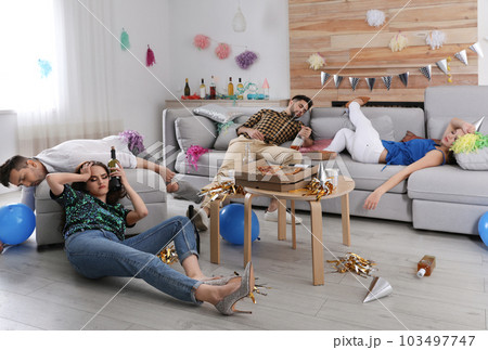 Drunk friends sleeping in messy room after party Drunk friends sleeping in messy room after party 103497747