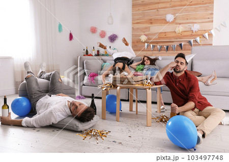 Drunk friends sleeping in messy room after party Drunk friends sleeping in messy room after party 103497748