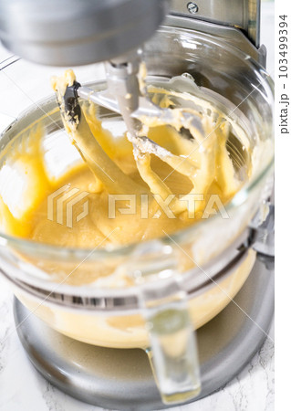 Mixing ingredients into the batter for lemon pound cake. 103499394