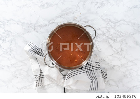 Flat lay. Cooking Mexican rice in a stainless steel cooking pot. Flat lay. Cooking Mexican rice in a stainless steel cooking pot. 103499586
