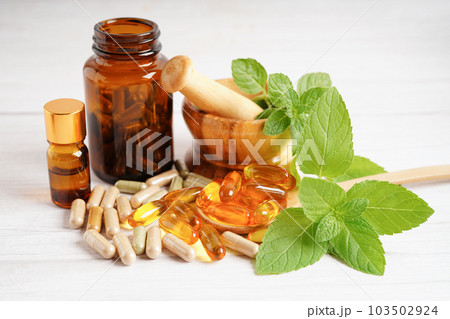 Alternative medicine herbal organic capsule with vitamin E omega 3 fish oil, mineral, drug with herbs leaf natural supplements for healthy good life. Alternative medicine herbal organic capsule with vitamin E omega 3 fish oil, mineral, drug with herbs leaf natural supplements for healthy good life. 103502924