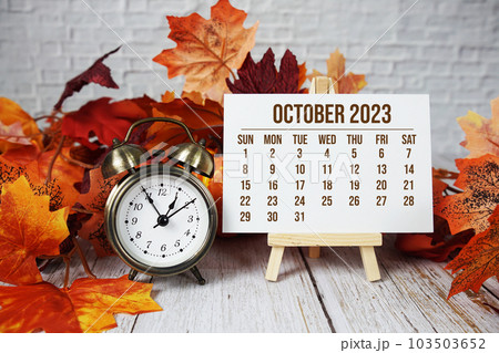 October 2023 monthly calendar maple leaf decoration on wooden background 103503652