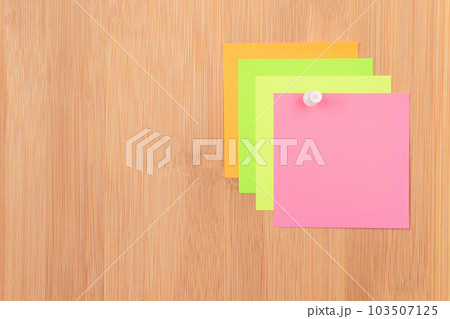 Colored Sticky Notes Pinned to the Wooden Message Board 103507125