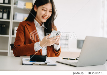businesswoman hand using smart phone, tablet payments and holding credit card online shopping, omni channel, digital tablet docking keyboard computer at office i. businesswoman hand using smart phone, tablet payments and holding credit card online shopping, omni channel, digital tablet docking keyboard computer at office i. 103508436