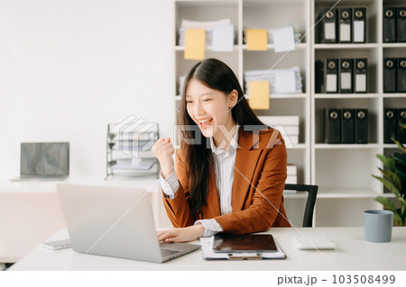 Asian business woman are delighted and happy with the work they do on their tablet, laptop and taking notes at the office.. Asian business woman are delighted and happy with the work they do on their tablet, laptop and taking notes at the office.. 103508499