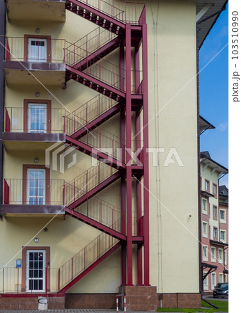 The painted red outdoor fire escape to the floors 103510990