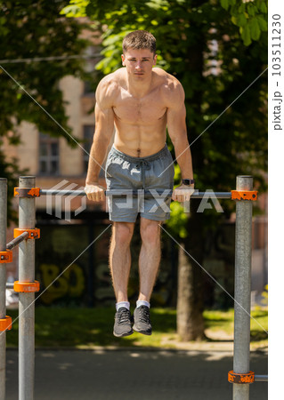 Athletic caucasian topless muscular training force push up, pull up exercise, strength gymnastics Athletic caucasian topless muscular training force push up, pull up exercise, strength gymnastics 103511230