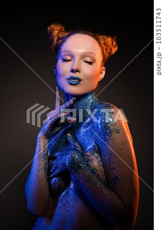 Naughty young naked lady with body art showing painted lips in studio Naughty young naked lady with body art showing painted lips in studio 103511743