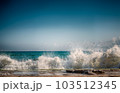 Stone beach on the sea with lots of foam and splashes 103512345