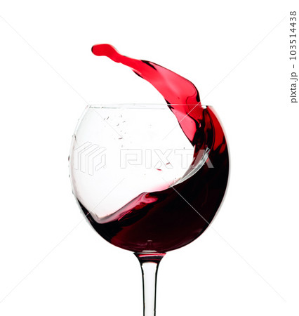 Splash of red wine in a glass isolated on  white. 103514438
