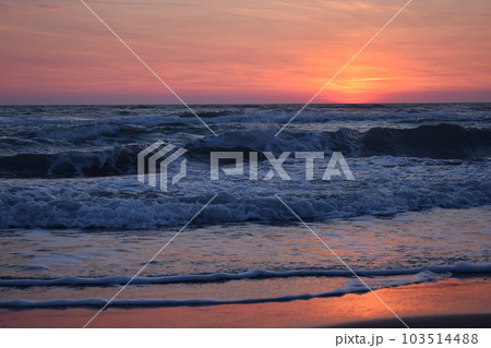A beautiful sunset on the beach in the turbulent ocean A beautiful sunset on the beach in the turbulent ocean 103514488