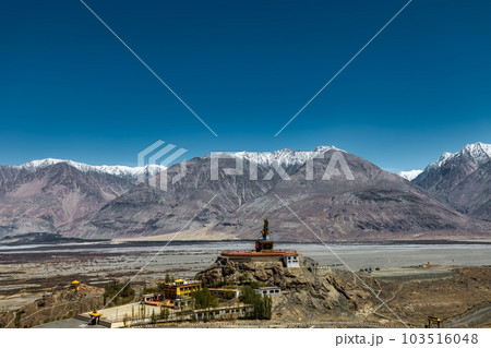 Big Sitting Buddha Statue at Diskit Monastery with Himalaya Range in the back - Nubra Valley, Ladakh, India. Big Sitting Buddha Statue at Diskit Monastery with Himalaya Range in the back - Nubra Valley, Ladakh, India. 103516048