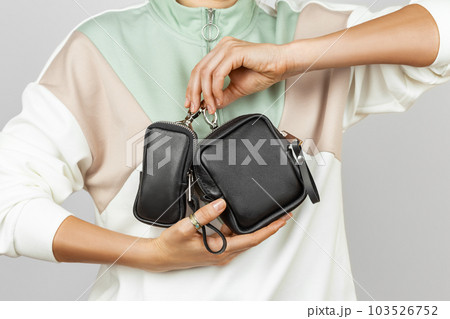 Female Hands Holding Small Leather Coin Purses 103526752