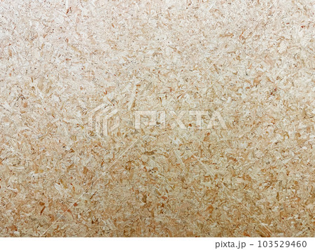 細かい木片を圧縮した木地色のパーティクルボードの表面の背景画像 103529460