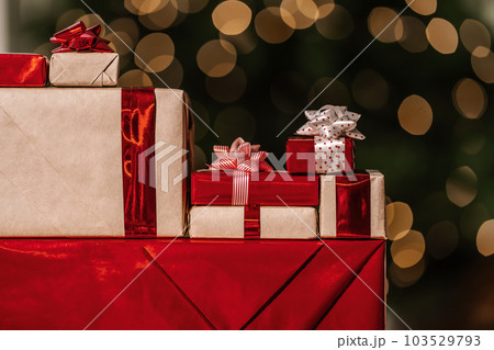 Gifts on the background of a Christmas tree with a bokeh. Gifts on the background of a Christmas tree with a bokeh. 103529793
