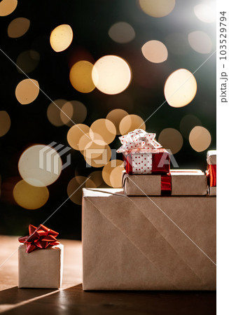 Gifts on the background of a Christmas tree with a bokeh. Gifts on the background of a Christmas tree with a bokeh. 103529794