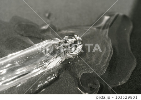 The texture of serum or oil with a pipette on a beige background. 103529801