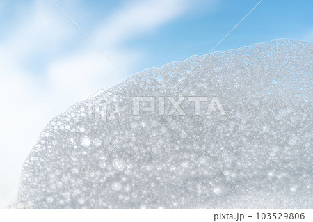 Texture of white foam on a sky background. 103529806