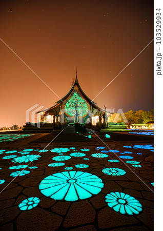 Architecture of Church temple with bodhi tree glowing and fluorescence lotus painting on the floor at Wat Sirindhorn Wararam or Wat Phu Prao 103529934