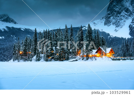 Emerald Lake with wooden lodge glowing in snowy pine forest on winter at Yoho national park Emerald Lake with wooden lodge glowing in snowy pine forest on winter at Yoho national park 103529961