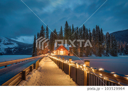 Emerald Lake with wooden lodge glowing in snowy pine forest on winter at Yoho national park Emerald Lake with wooden lodge glowing in snowy pine forest on winter at Yoho national park 103529964