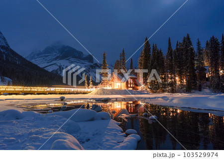 Emerald Lake with wooden lodge glowing in snowy pine forest on winter at Yoho national park Emerald Lake with wooden lodge glowing in snowy pine forest on winter at Yoho national park 103529974
