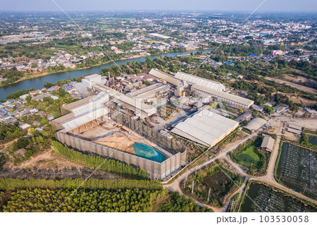 Sugar cane biomass processing plant with warehouse, tank and harvester truck in factory Sugar cane biomass processing plant with warehouse, tank and harvester truck in factory 103530058