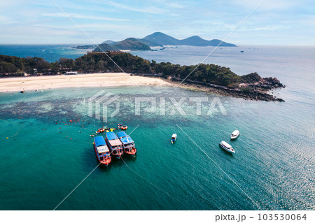 Scenery of tropical sea beach with boat anchored and tourist with leisure activity in summer on sunny day at Koh Larn Scenery of tropical sea beach with boat anchored and tourist with leisure activity in summer on sunny day at Koh Larn 103530064