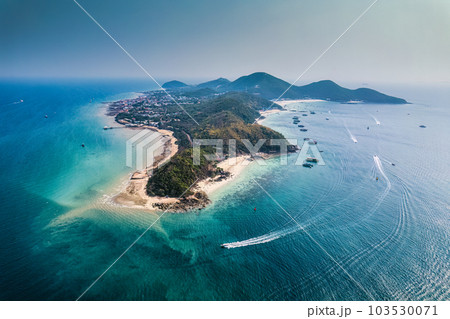 Beautiful tropical sea beach with boat anchored and tourist playing water sports in summer on sunny day at Koh Larn 103530071