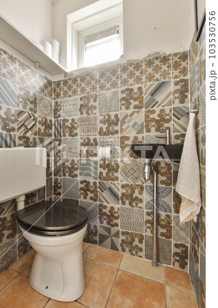 a bathroom with tiles on the wall and toilet in the corner, which has been used for many years to make it look like a bathroom with tiles on the wall and toilet in the corner, which has been used for many years to make it look like 103530756
