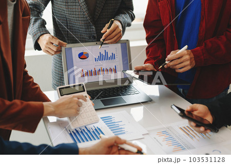 Business team meeting present.professional investor working with  Finance managers task. with laptop smart phone and digital tablet in morning light. 103531128