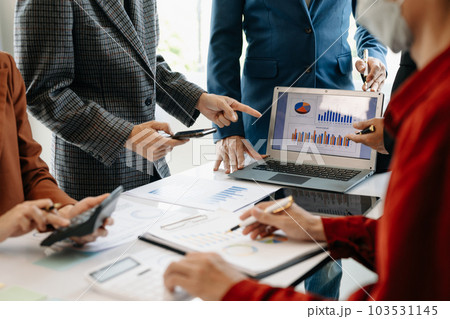 Businessman and team analyzing financial statement Finance task. with smart phone and laptop and  tablet. Wealth management concept. 103531145