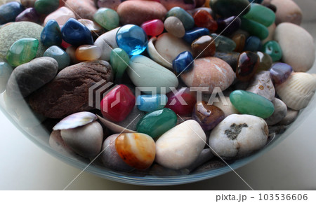 Colored Minerals And Smooth Sea Stones In A Transparent Vase Colored Minerals And Smooth Sea Stones In A Transparent Vase 103536606