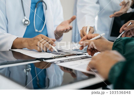 Medical team working on digital tablet healthcare doctor technology tablet using computer analyzed the results of medical reports at the hospital. 103536848