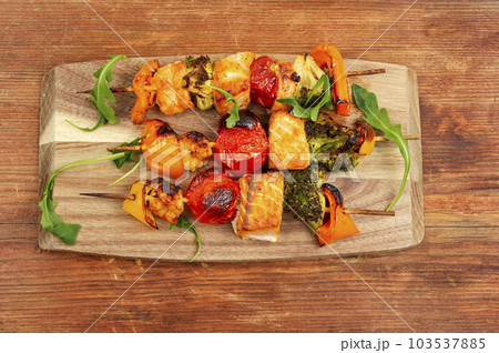 Seafood kebab on vintage wooden board. Seafood kebab on vintage wooden board. 103537885