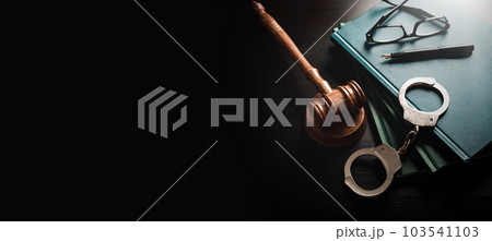 Handcuffs and wooden gavel. Law concept 103541103