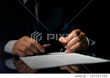 Notary public in office signing document Notary public in office signing document 103541109