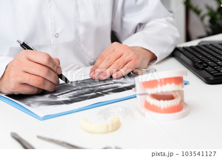 Dentist shows problem areas in teeth Dentist shows problem areas in teeth 103541127