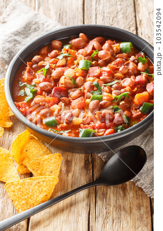 Mexican Charro Beans or Frijoles Charros with bacon, tomato, onions, ham, and jalapenos closeup on the bowl. Vertical Mexican Charro Beans or Frijoles Charros with bacon, tomato, onions, ham, and jalapenos closeup on the bowl. Vertical 103542094