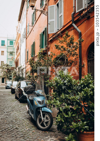 Italian scooter and cars parking at old building in rome, traveling background. Typical street in Rome, Italy. Italian scooter and cars parking at old building in rome, traveling background. Typical street in Rome, Italy. 103542355