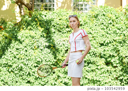 Sports fashion. Beautiful middle aged woman in tennis activewear 103542959