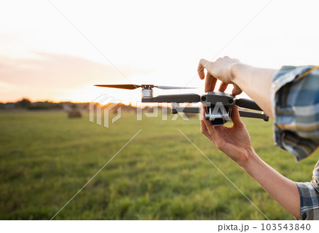 Farmer with drone. Smart farming and precision agriculture 103543840