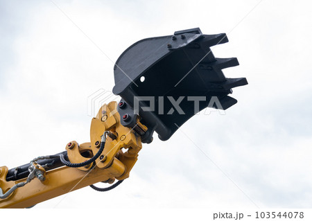 Close up of excavator bucket on a background of sky 103544078