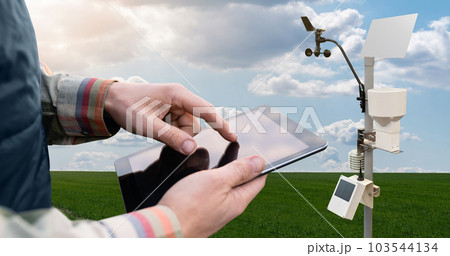 Farmer control weather station via digital tablet. Precision and smart farming equipment 103544134