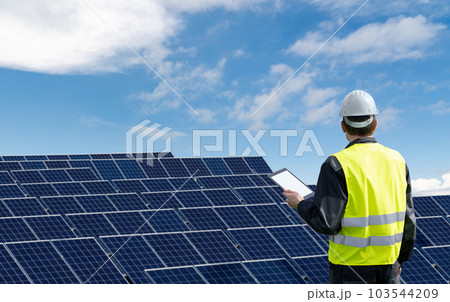 Engineer with tablet computer on a background of solar energy power station Engineer with tablet computer on a background of solar energy power station 103544209