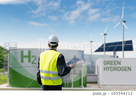 Engineer with tablet computer on a background of Green Hydrogen factory Engineer with tablet computer on a background of Green Hydrogen factory 103544212