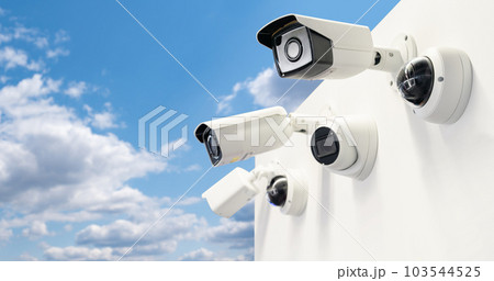 Surveillance cameras on a background of blue sky. Perimeter security. Surveillance cameras on a background of blue sky. Perimeter security. 103544525